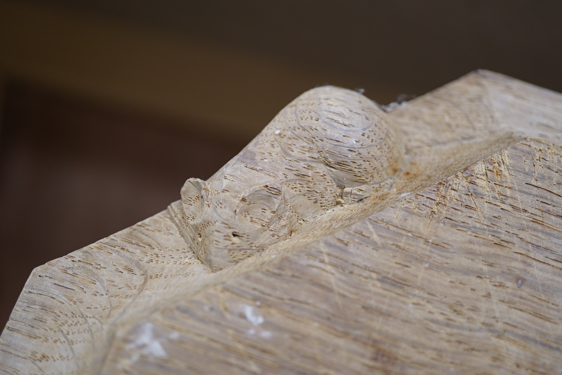 A Mouseman carved oak octagonal bread board, 30cm wide x 25cm deep. Condition - faded and scored